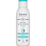 A white bottle of Lavera Basis Sensitiv Body Lotion Express 250ml for normal or sensitive skin, featuring organic aloe vera and jojoba oil on the label and a blue water splash graphic on the front.