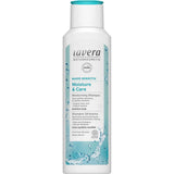 A white 250ml bottle of Lavera Basis Sensitiv Shampoo - Moisture & Care with a turquoise cap, formulated with organic aloe vera and jojoba for sensitive, dandruff-prone scalps.