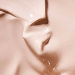 Close-up of a smooth, creamy beige liquid with subtle swirls and texture, labeled Colour: Light—perfect for highlighting the Hyaluronic Anti-Pollution CC Cream SPF15 40ml in your skincare routine.