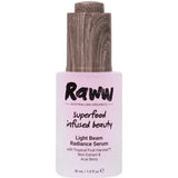A 30ml bottle of Raww Light Beam Radiance Serum with a wooden-textured cap and pink label, enriched with natural exfoliant AHAs to promote glowing, healthy-looking skin.