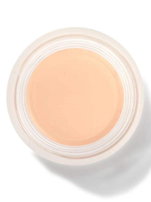 An open round pot of Alpine Rose Long Last Concealer, viewed from above, showing smooth pale peach beige cream within a white rim.