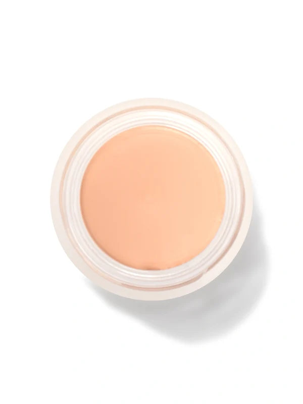 An open round pot of Crème Long Last Concealer, viewed from above, showing smooth pale peach cream within a white rim.