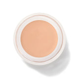 An open round pot of White Peach Long Last Concealer, viewed from above, showing smooth light peach beige cream within a white rim.