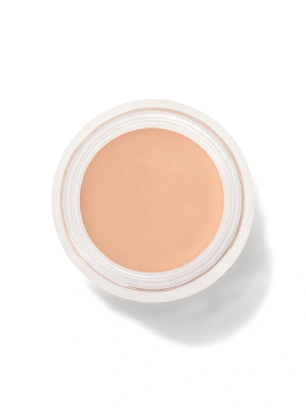 An open round pot of White Peach Long Last Concealer, viewed from above, showing smooth light peach beige cream within a white rim.