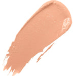 A diagonal swatch of Golden Peach Long Last Concealer in warm golden peach, with a creamy sheen and a rounded end tapering into fine streaks.
