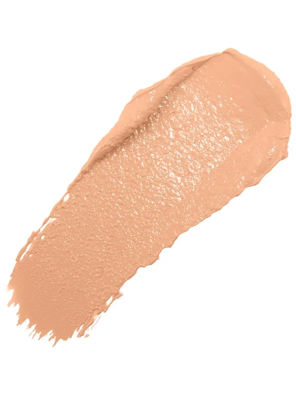 A diagonal swatch of Peach Bisque Long Last Concealer in warm peach beige, with a creamy sheen and a thick rounded end tapering into fine streaks.