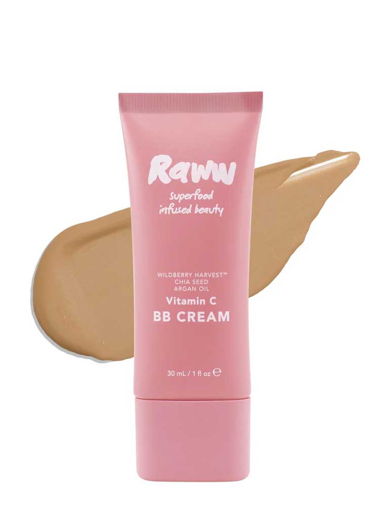 A pink tube of RAWW Vitamin C BB Cream 30ml stands before a beige swipe, showcasing the hydrating formula with wildberry harvest, chia seed, and argan oil for a radiant complexion and creamy texture.