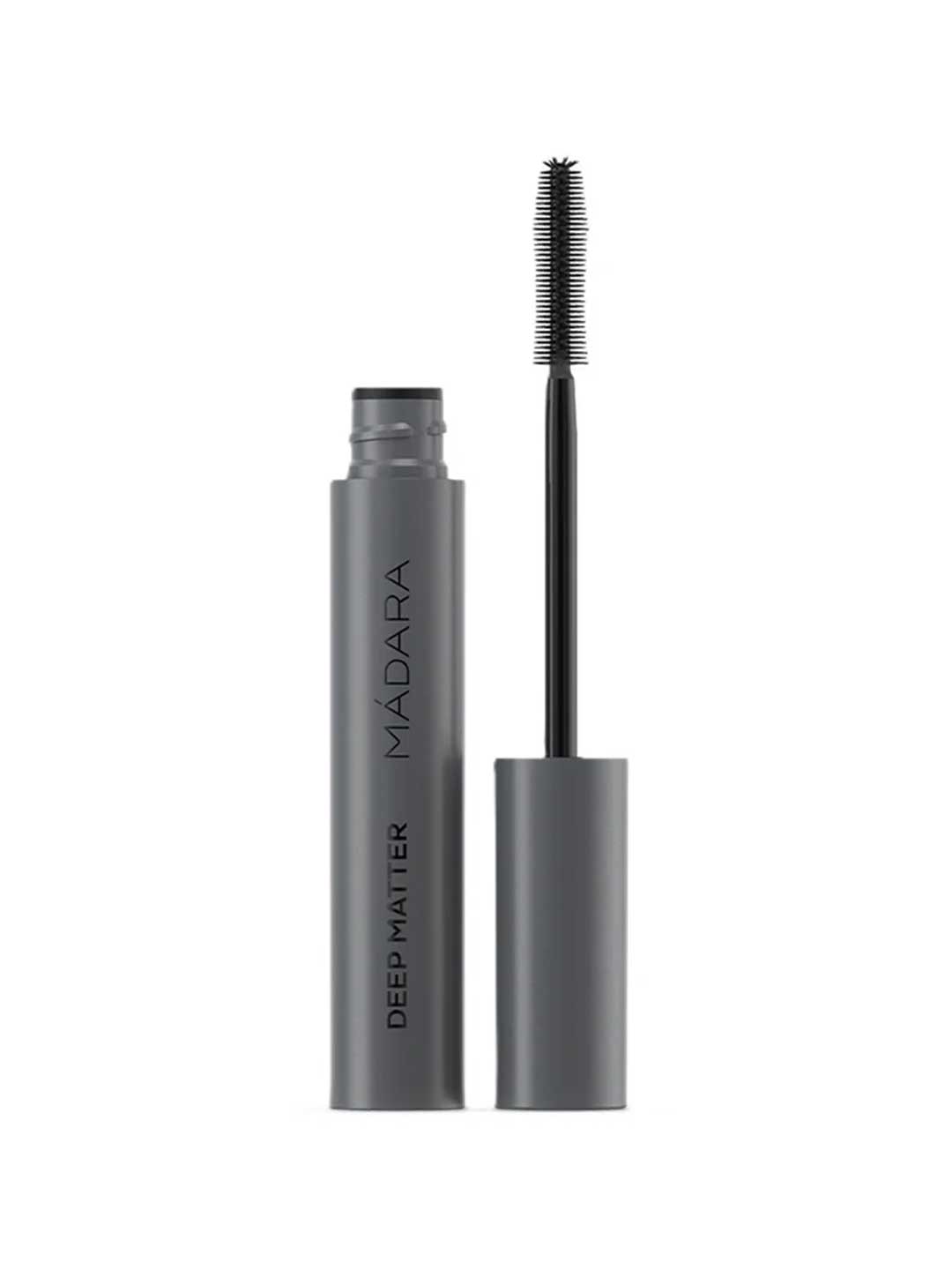 A gray tube of Madara Bold Volume Mascara - Deep Matter 6ml with the cap removed, showing a black wand with fine bristles. The product name appears vertically on the tube.