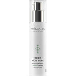 A white bottle of Madara Deep Moisture Night Cream 50ml features a pump dispenser, minimal design with a green plant graphic, and is enriched with hydrating hyaluronic acid for overnight skin renewal.