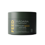 A dark green 180ml jar of Madara Feed Repair Dry Rescue Hair Mask, featuring white and yellow text and highlighting its intensive conditioning ingredients on the label.