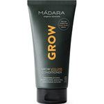 The Madara Grow Volume Conditioner 175ml is a black tube with yellow and white text, ideal for fine or thinning hair. Featuring chanterelle fungi, this silicone-free conditioner comes in plant-based packaging and stands upright on a white background.