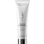 The Madara Melting Cleansing Oil 100ml comes in a white tube with black text and a minimalist plant design. This natural oil cleanser nourishes skin, rinses off easily, and effectively removes makeup and sunscreen.