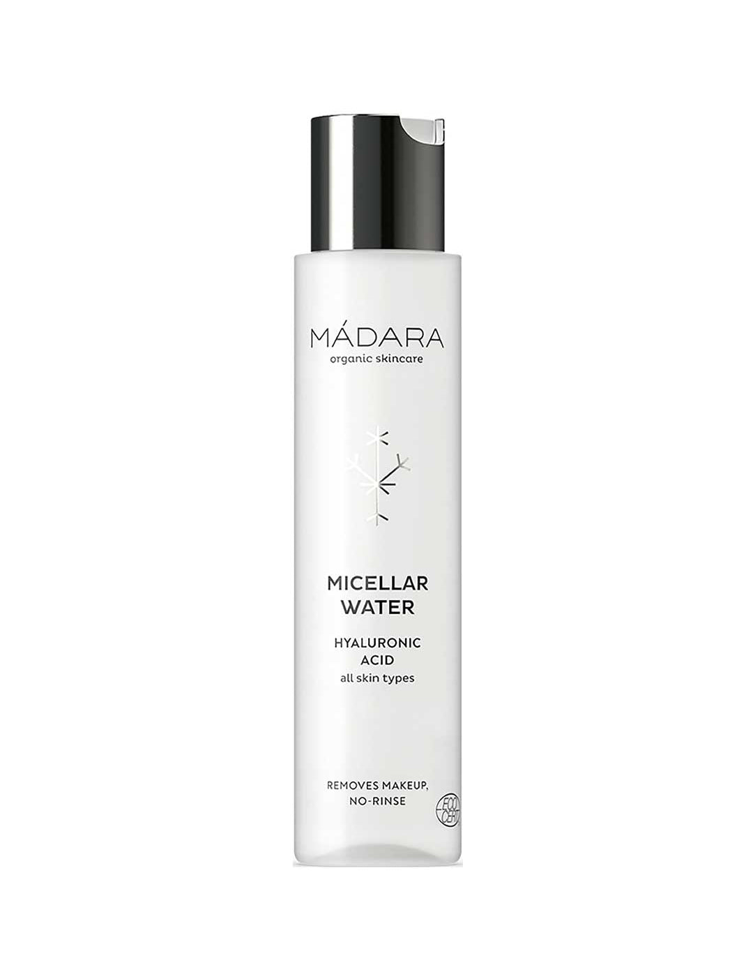 A 100ml white bottle of Madara Micellar Water with a silver cap and minimalist design. Suitable for all skin types, it removes makeup without rinsing. Contains hyaluronic acid and is vegan according to the label.