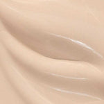 Close-up of Madara Skin Equal Soft Glow Foundation SPF15 30ml in Porcelain #10—a smooth, creamy light beige mineral formula with subtle swirls and a glossy, dewy finish.