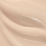 Close-up of Madara Skin Equal Soft Glow Foundation SPF15 30ml in Porcelain #10—a smooth, creamy light beige mineral formula with subtle swirls and a glossy, dewy finish.