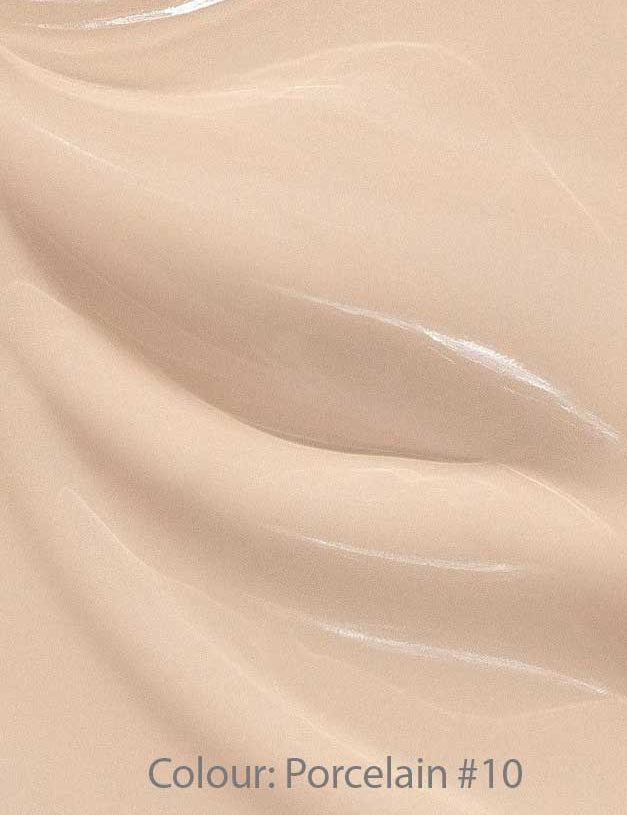 Close-up of Madara Skin Equal Soft Glow Foundation SPF15 30ml in Porcelain #10—a smooth, creamy light beige mineral formula with subtle swirls and a glossy, dewy finish.