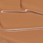 Madara Skin Equal Soft Glow Foundation SPF15 30ml in Caramel #70 swatched with glossy streaks and ripples, delivering a radiant, dewy finish. Colour: Caramel #70.