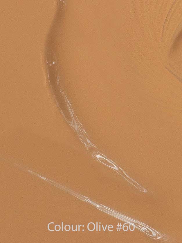 Close-up of Madara Skin Equal Soft Glow Foundation SPF15 30ml in a creamy warm olive shade with visible brush strokes. Text at the bottom reads: Colour: Olive #60.