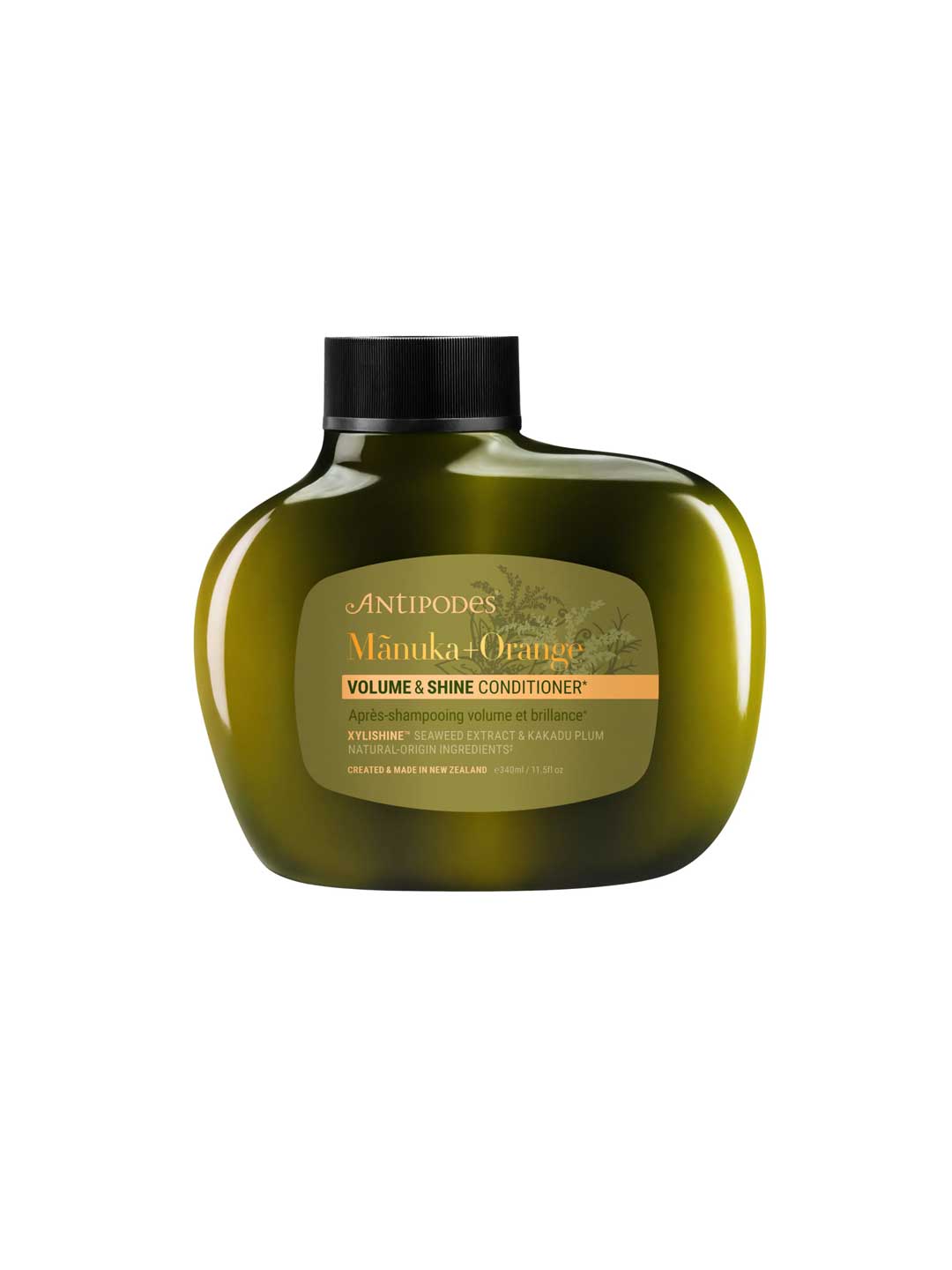 An olive green bottle of Antipodes Manuka + Orange Volume & Shine Conditioner 340ml with a black cap, shown on a white background. The label emphasizes its silicone-free formula, natural ingredients, and volumizing benefits.