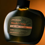 Antipodes Manuka and Orange Volume and Shine Conditioner bottle with product pour