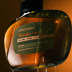 Antipodes Manuka and Orange Volume and Shine Shampoo bottle with product pour