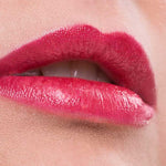 Close-up of lips wearing Benecos Natural Lipsticks 4.5g in bright pink, slightly parted to show teeth. The background is soft pink, with "Marry Me" written below the image.
