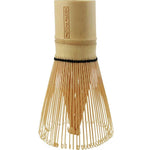 The Matcha Maiden Bamboo Matcha Whisk features fine curved tines and a cylindrical handle, standing upright on a white background.