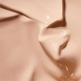 Close-up of a smooth, creamy beige liquid with a glossy texture, likely Hyaluronic Anti-Pollution CC Cream SPF15 40ml; 'Colour: Medium' appears at the bottom.