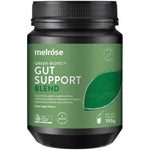 A black jar of Melrose Green-Biotic Gut Support Certified Organic Blend 195g, green apple flavor, features a green label. This probiotic supplement contains prebiotics, probiotics, and postbiotics for optimal gut health.