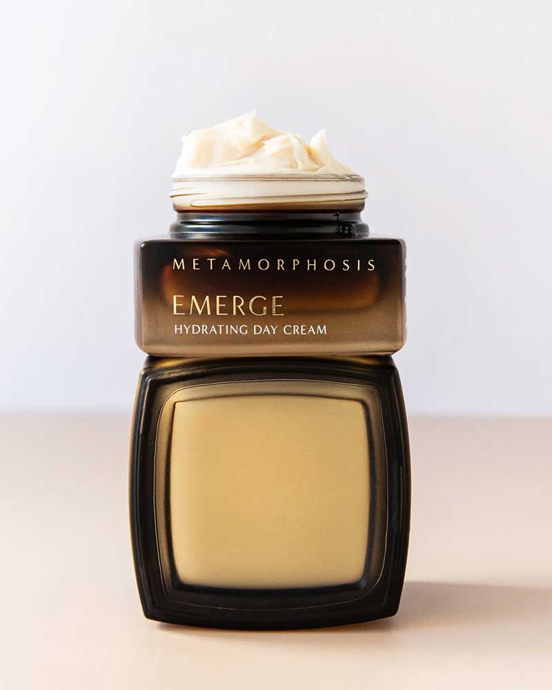 The Metamorphosis Emerge Hydrating Day Cream 50ml, shown open with a swirl of cream on top against a light background, is ideal for menopausal skin and helps support the skin barrier.