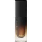A 30ml bottle of Metamorphosis Illuminate Cellular Repair Day Cream with a black cap and gradient black-to-clear lower half, gold text branding, designed for anti-aging and collagen boosting.