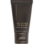 A black tube labeled Metamorphosis The Other Lips Balm™ 50ml stands upright against a white background, featuring gold and white text—perfect as a natural intimate balm for menopause dryness relief.