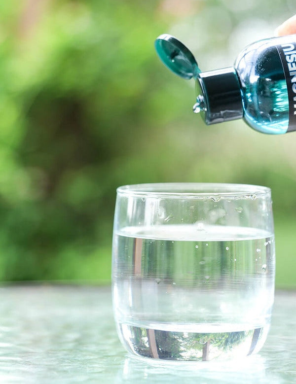 Elektra Magnesium Mineral Drops poured into water