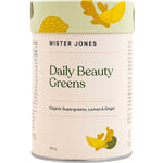 A cylindrical container of Mister Jones Daily Beauty Greens 180g, labeled Organic Supergreens Powder with vegan collagen boosters, Lemon & Ginger, and adorned with yellow and green leaf designs on a cream background.