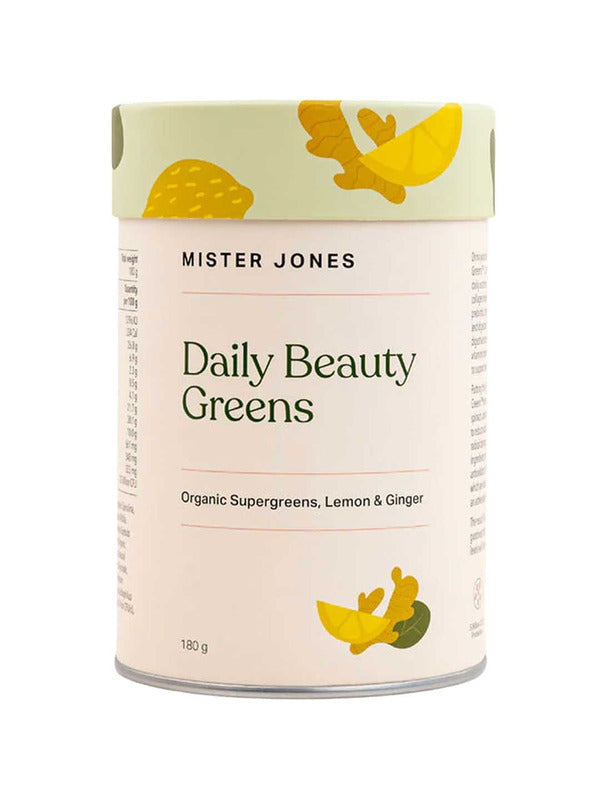 A cylindrical container of Mister Jones Daily Beauty Greens 180g, labeled Organic Supergreens Powder with vegan collagen boosters, Lemon & Ginger, and adorned with yellow and green leaf designs on a cream background.