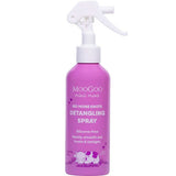 A pink 150ml bottle of MooGoo Mini Moo Natural Detangling Spray, a kid-friendly hair product with a white spray nozzle, featuring a cartoon cow and highlighting its silicone-free formula for smoothing knots and tangles.