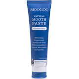 MooGoo natural mouthpaste in a dark blue tube on a white background