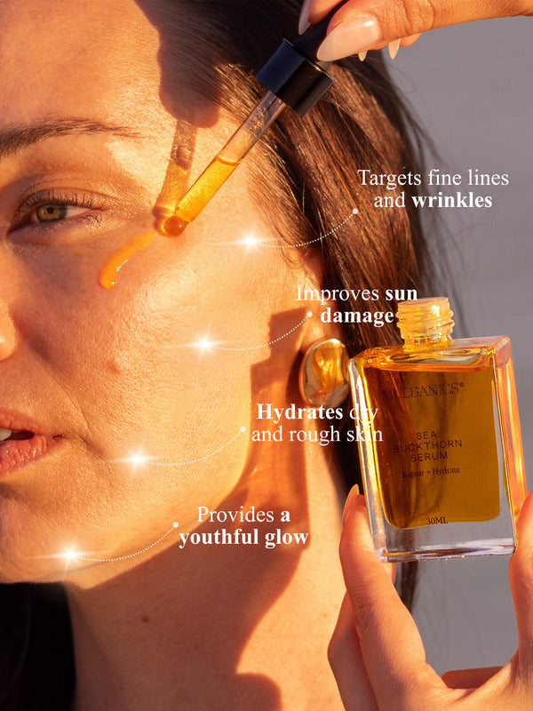 Woman applying Mud Organics Sea Buckthorn Serum in warm sunlight