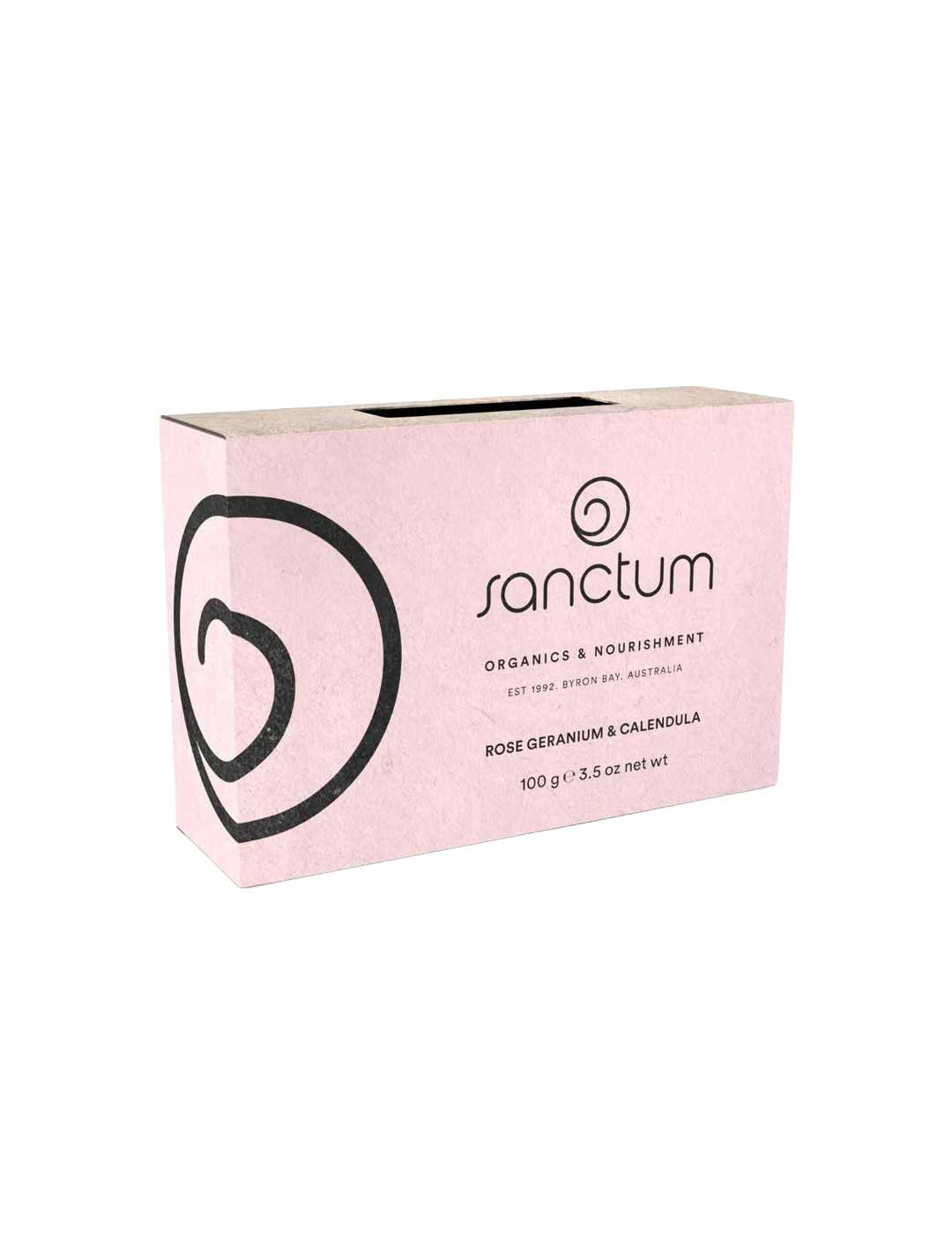 A pink rectangular box of Sanctum Rose Geranium & Calendula Soap 100g features black text and a swirl design, highlighting this natural, soothing organic bar for nourishment by Sanctum.