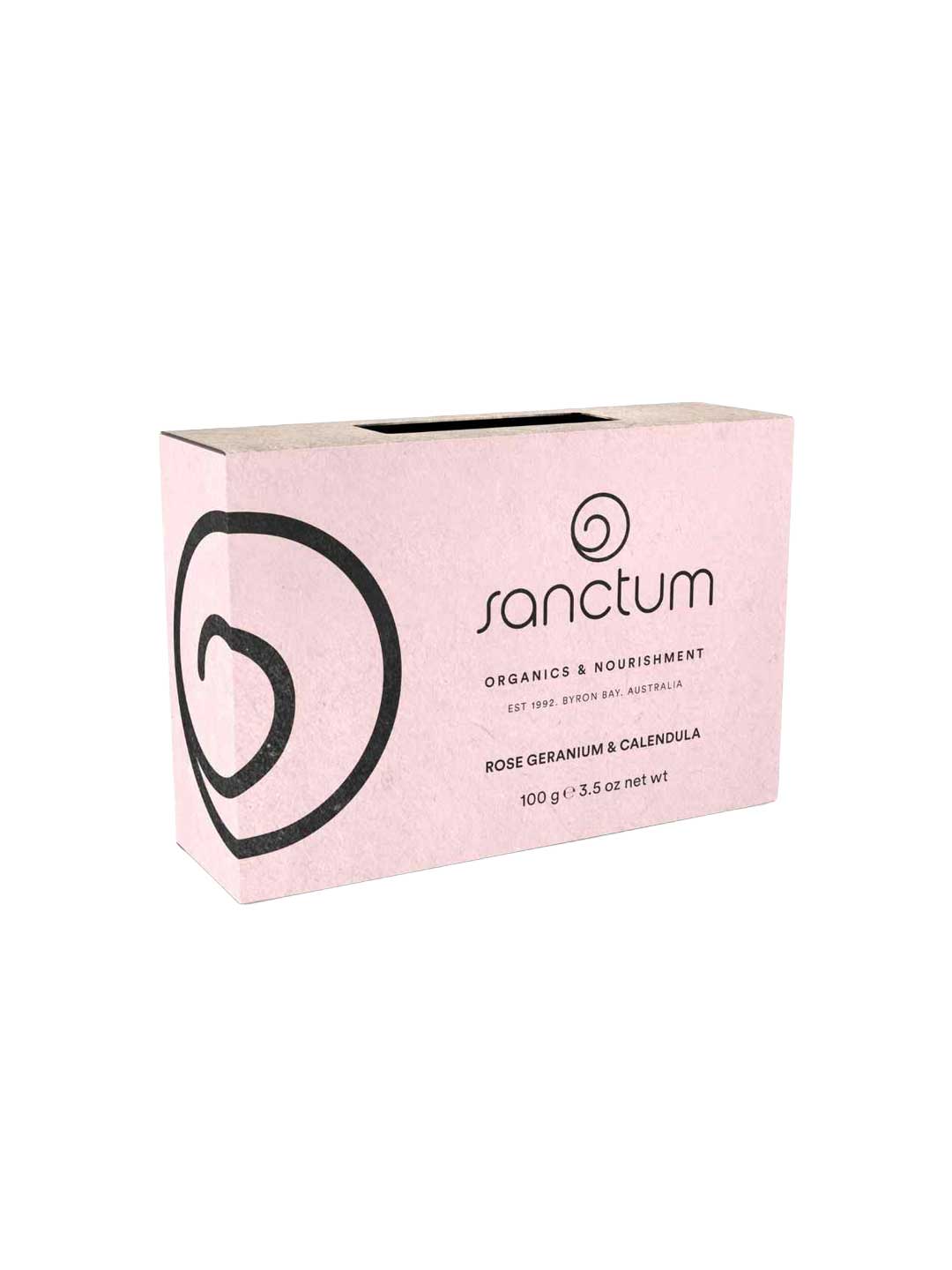 A pink rectangular box of Sanctum Rose Geranium & Calendula Soap 100g features black text and a swirl design, highlighting this natural, soothing organic bar for nourishment by Sanctum.