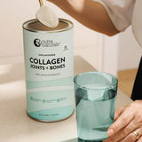 Spooning Nutra Naturals Collagen Joints and Bones into a glass