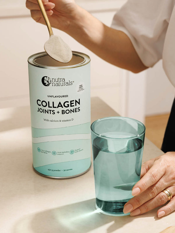 Spooning Nutra Naturals Collagen Joints and Bones into a glass