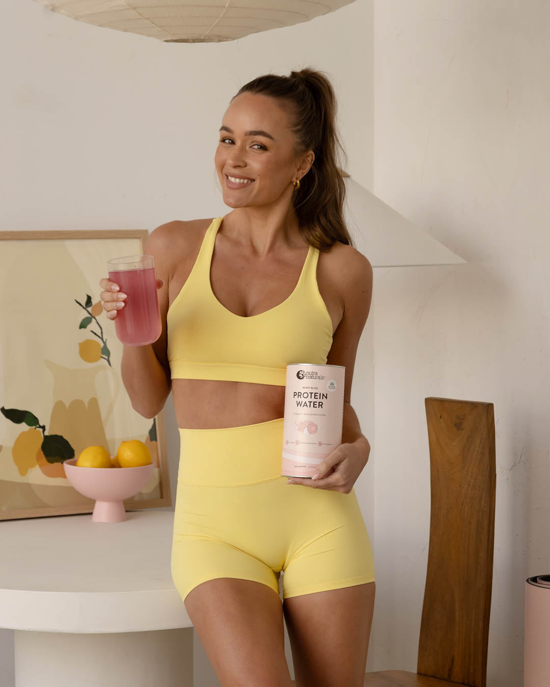 Woman holding Nutra Naturals Protein Water Berry Bliss