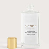 A clear glass bottle of Sienna Byron Bay Strengthening Nail Polish Remover with a gold cap sits beside it against a plain light background. The label reads Natural & Gentle and features plant-based ingredients for healthier nails.
