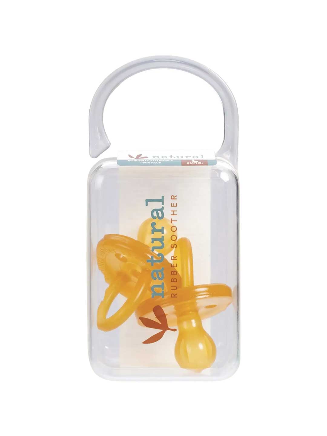 A clear plastic case with a curved handle holds two yellow Natural Rubber Soother Twin Pack Large Rounded 6 mths+ pacifiers. The label reads "natural rubber soother.