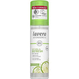 A bottle of Lavera Deodorant Spray - Natural & Refresh 75ml with a green cap features the label “New Formula,” vegan, climate neutral, and images of lime slices and mint leaves.