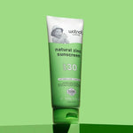 Wotnot Natural Baby Sunscreen SPF 30 tube on green background