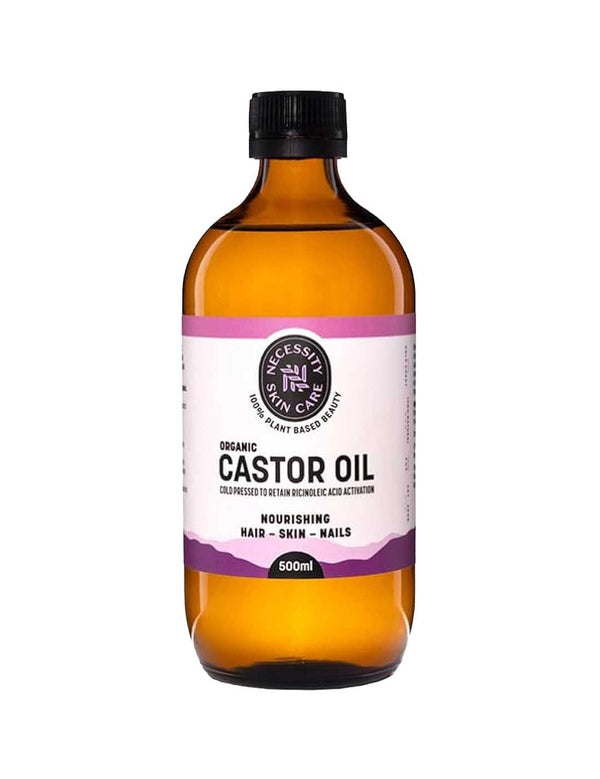 Large amber Necessity Organic Castor Oil bottle with a black screw cap and a white label bordered by pink and purple bands.