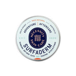 Necessity Surfaderm™ 60g is a round tin for adventure aftercare—soothes sunburn, dry skin, cuts, chafing, bites, and stings. Features blue, orange, and black text on white. Made with natural ingredients for skin comfort.