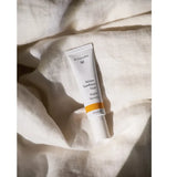 Dr Hauschka Night Serum styled on bed sheets